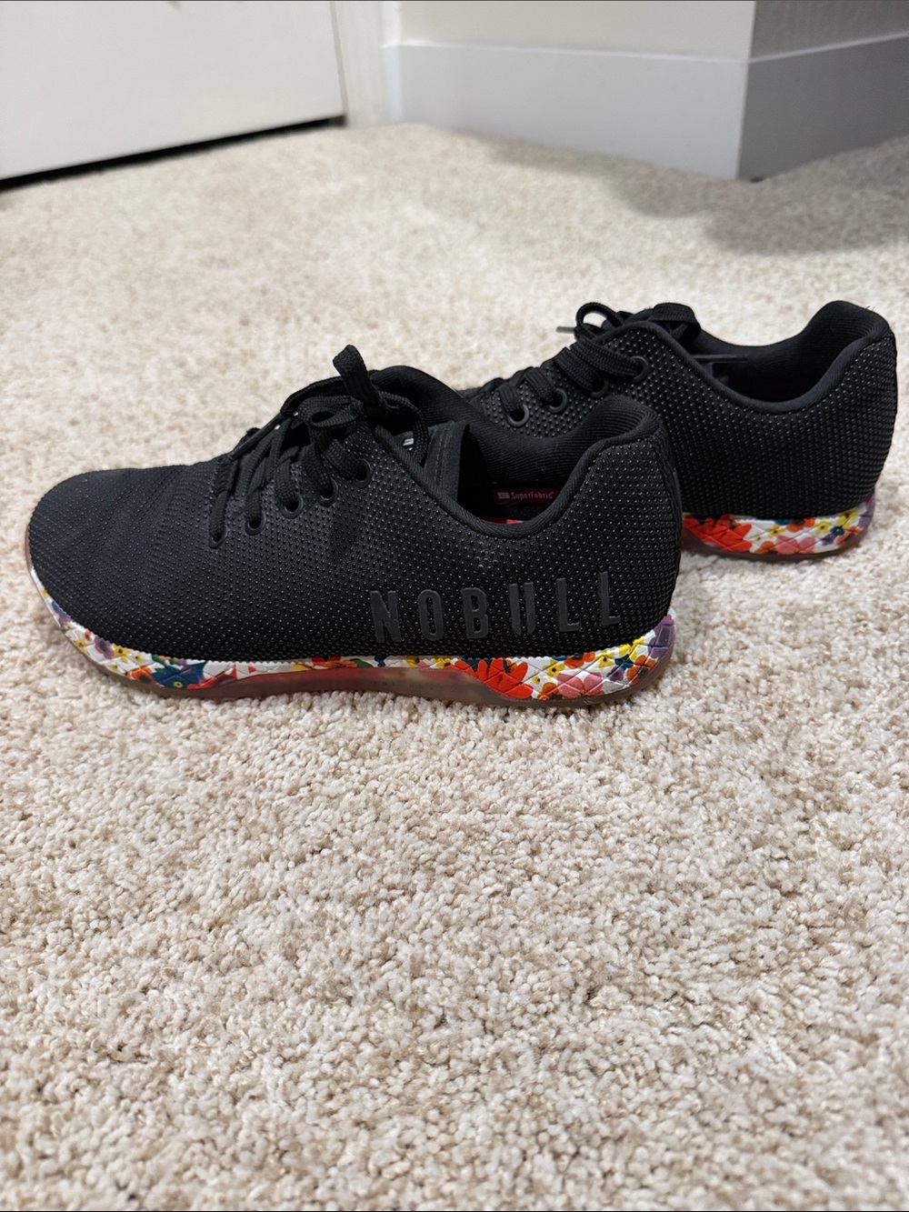 NOBULL Women’s Black Knit Trainer with Multicolor Floral Sole